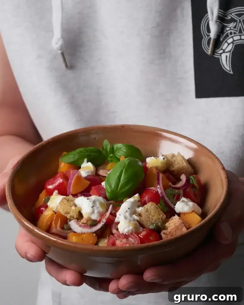 A rustic wooden board laden with fresh summer fruits like watermelon, berries, and melon, alongside cheese and crackers.