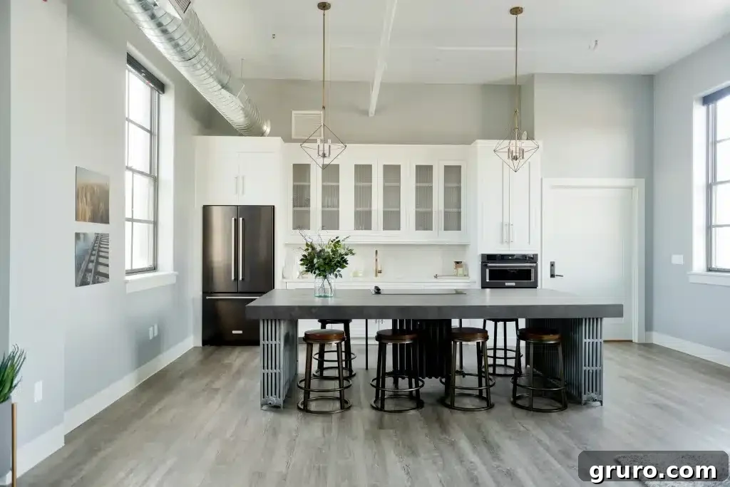 A modern farmhouse kitchen with light gray walls, dark cabinetry, and white countertops, illustrating a balanced color scheme.