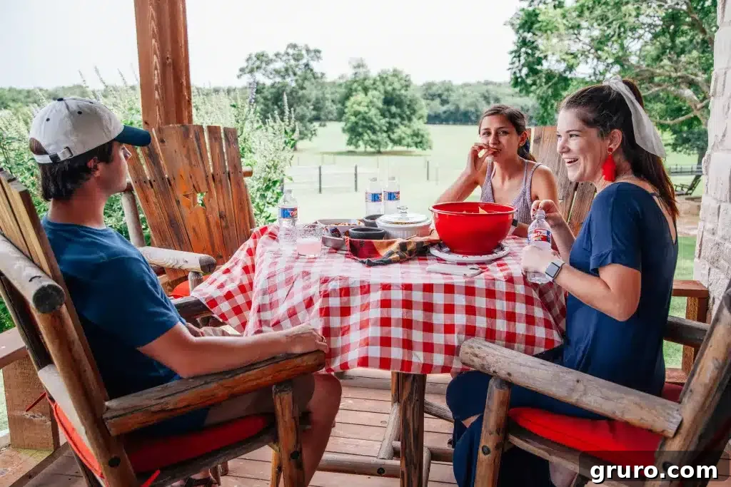 A beautifully set picnic blanket with an assortment of food and drinks.