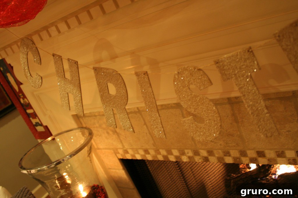 A detailed shot of sparkling Christmas decorations, possibly a cluster of ornaments or illuminated branches, reflecting light with a festive shimmer.