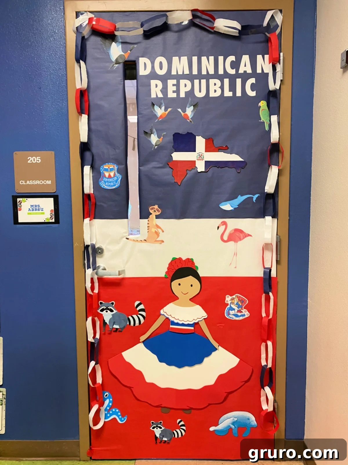Hispanic Heritage Month Door Decor Ideas 11 Blue, white, and red classroom door with a female and paper chains and the words Dominican Republic on the door.