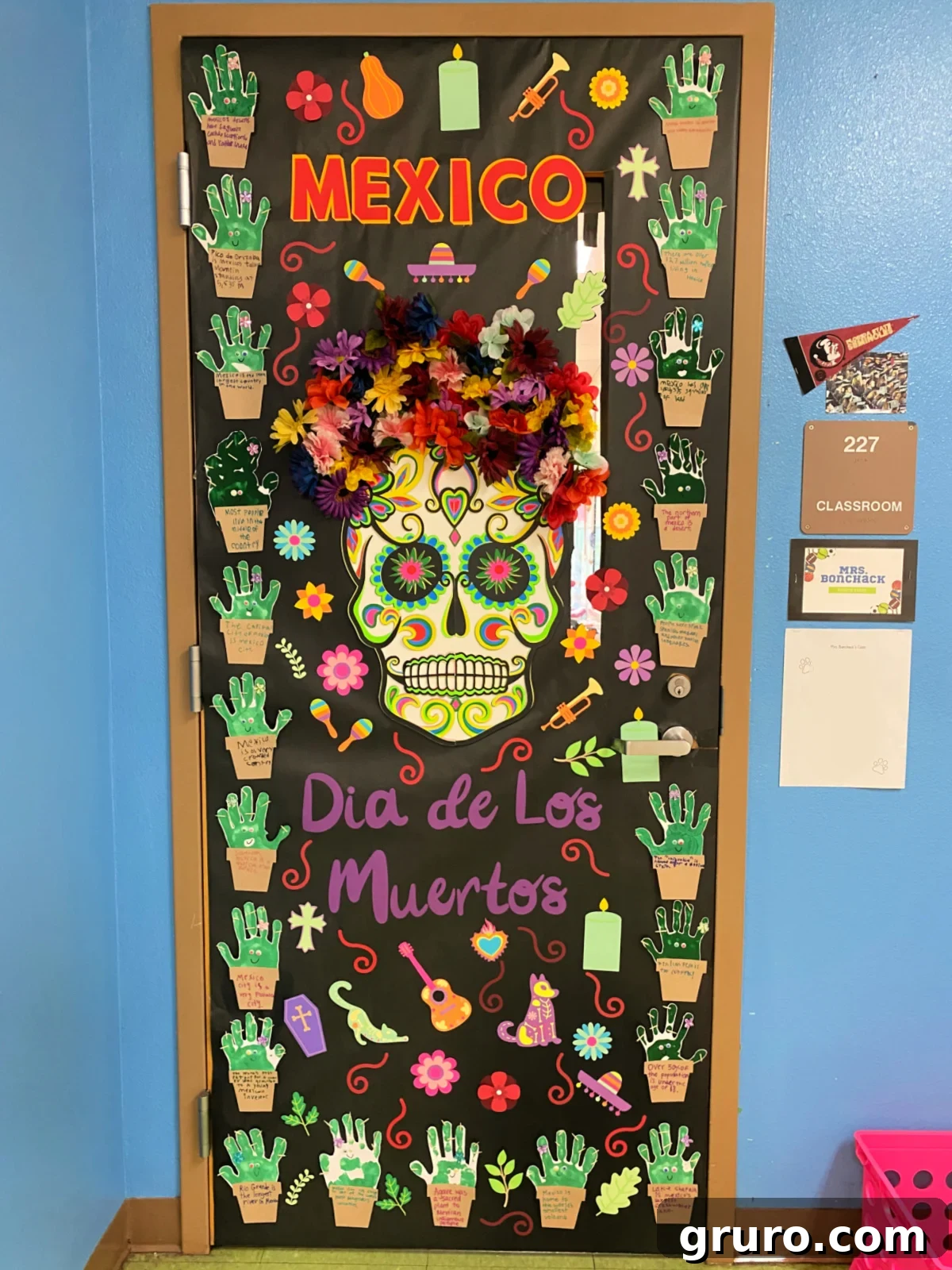 Hispanic Heritage Month Door Decor Ideas 17 Black paper door with a sugar skull that says Mexico Dia de Los Muertos.