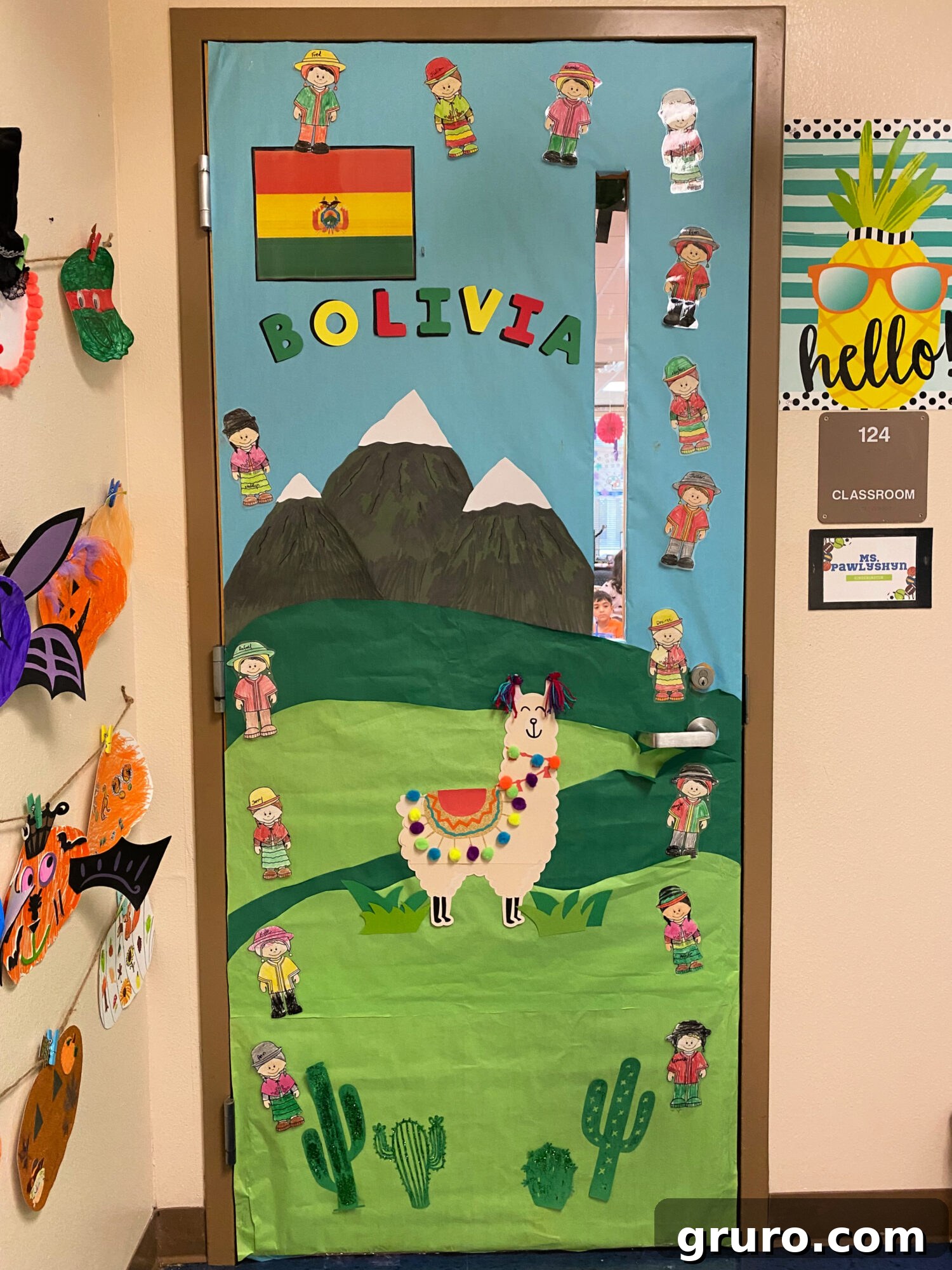 Hispanic Heritage Month Door Decor Ideas 4 Green door with mountains, llama, and crayon colored kids that says 'bolivia' on it.